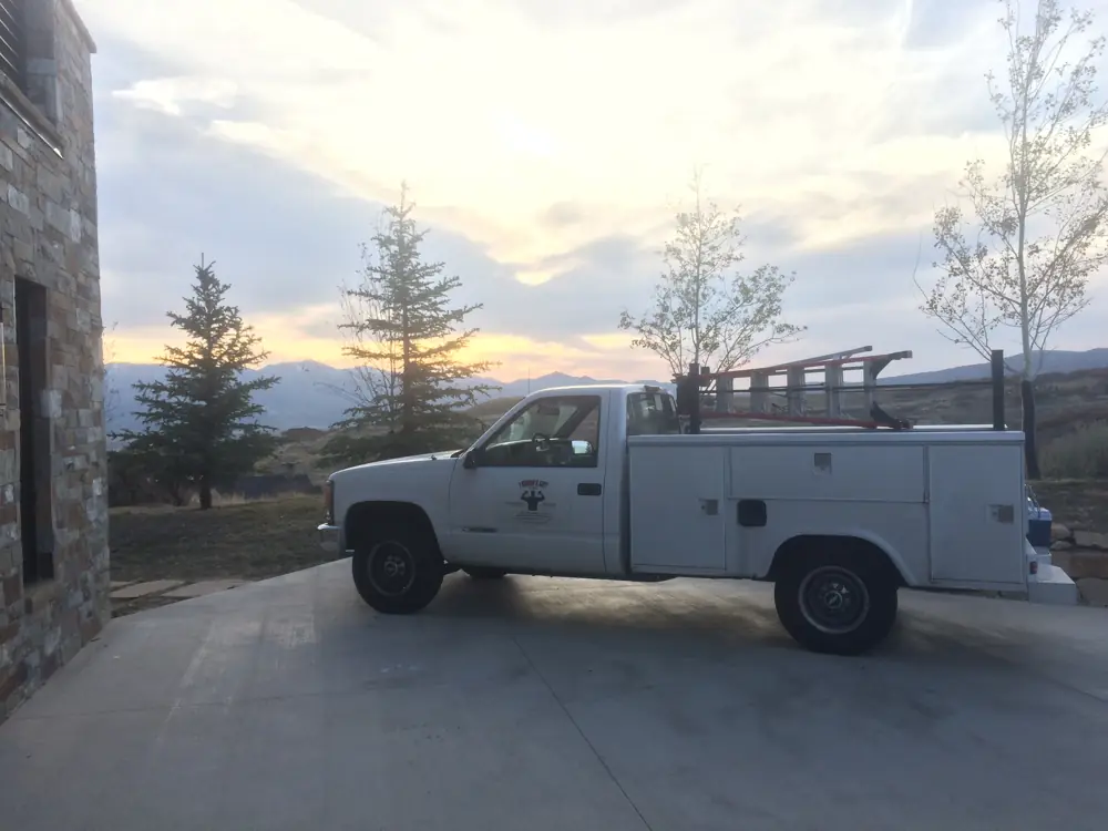 I Know A Guy HVAC service truck at sunset with the Wasatch foothills behind it