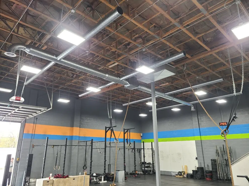 Exposed spiral ductwork installed in a new commercial gym build-out, a job by I Know A Guy HVAC in the Salt Lake Valley